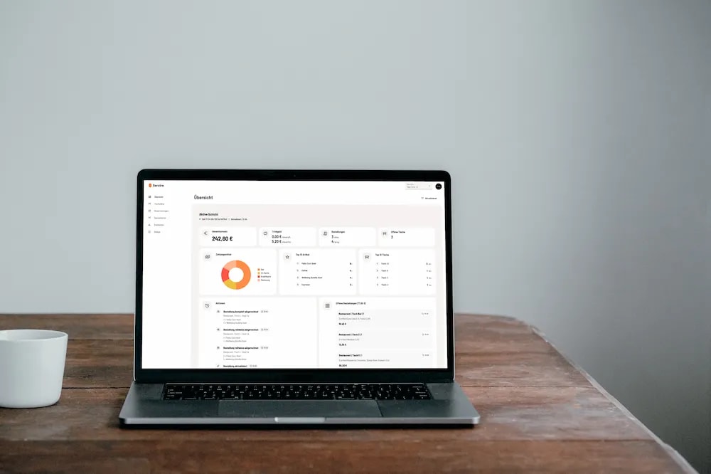 Web desk with reports and cash register filing on a MacBook
